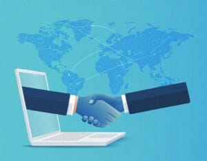 Western business owner and Indian professional shaking hands